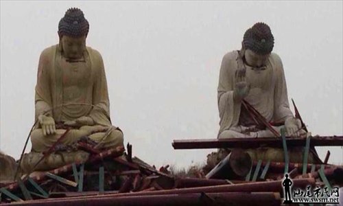 Two Buddha statues appear with their heads hung low on Tuesday, after Typhoon Usagi ravaged through Lufeng, Guangdong Province. Photo: swsm.net