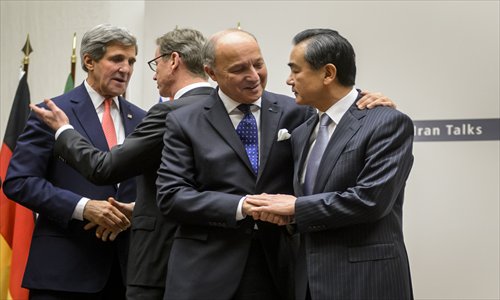 US Secretary of State John Kerry, German Foreign Minister Guido Westerwelle, French Foreign Minister Laurent Fabius and Chinese Foreign Minister Wang Yi talk after a statement on Sunday in Geneva. World powers on Sunday agreed a landmark deal with Iran halting parts of its nuclear program. Photo: AFP