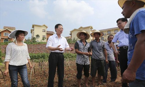 Chinese Vice Premier Zhang Gaoli (2nd L) inspects Nantiansi Village, Shuangliu County in southwest China's Sichuan Province, July 6, 2013. Zhang made a research tour in Sichuan from July 5 to July 8. Photo: Xinhua