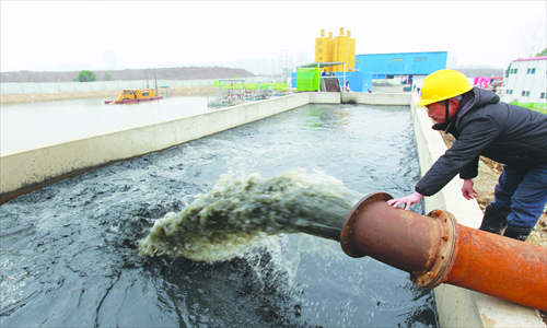 A worker in Hefei, East China's Anhui Province, checks the water status. Photo: CFP