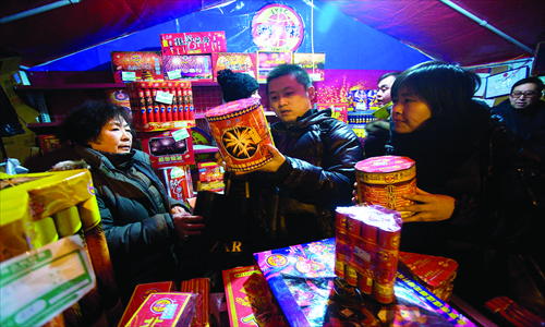 Residents buy fireworks at a stand in Gucheng, Shijingshan district, for the upcoming Spring Festival. Photo: Li Hao/GT