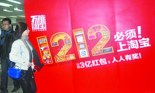 A pedestrian walks past an advertisement for taobao.com of Alibaba Group in Shanghai on Saturday, which promotes a sales campaign on Thursday. Photo: IC