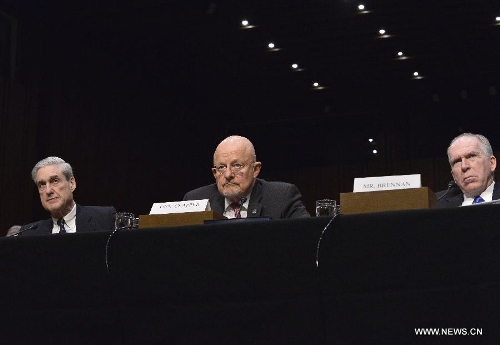 (L to R) FBI Director Robert Mueller, Director of National Intelligence James Clapper, and CIA Director John Brennan testify before the Senate Select Intelligence Committee during a hearing on 
