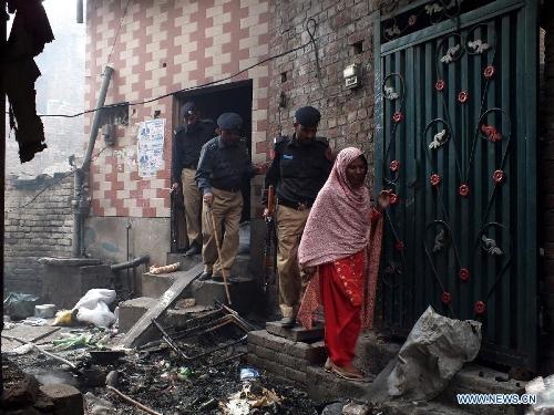 A Pakistani Christian woman visits the burnt out houses after attacked by demonstrators during a protest in a Christian neighborhood in Badami Bagh area of eastern Pakistan's Lahore on March 9, 2013. Angry mob torched over 100 houses and shops of minority Christians in Badami Bagh area on Saturday after a Christian boy was accused of blasphemy, police and residents said. (Xinhua/Jamil Ahmed) 