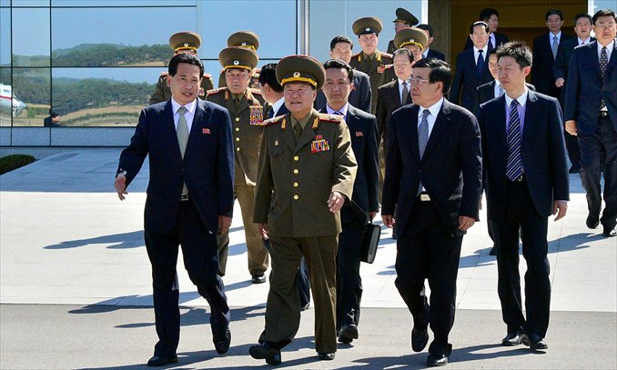 Choe Ryong-hae (center), director of the Korean People's Army politburo, leaves Pyongyang airport to visit China as a special envoy of North Korean leader Kim Jong-un Wednesday. Choe, a top official and confidant of Kim Jong-un, on Wednesday met a senior Chinese official in Beijing ahead of a China-US summit.Photo: AFP