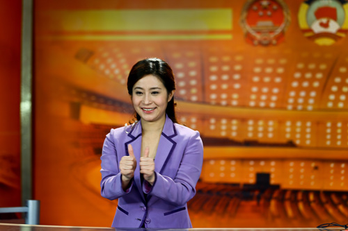 Zhang Lijun, a sign language expert, interprets during the live broadcast of the First Session of the 12th Chinese People's Political Consultative Conference (CPPCC) Saturday morning in Shanghai. Photo: Cai Xianmin /GT