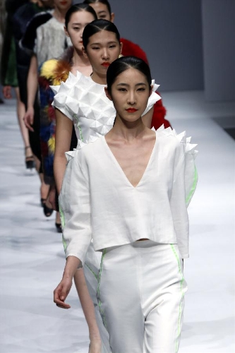 Models present creations designed by students from the Sino-French Institute of Fashion Designer in Shanghai University of Engineering Science during the first China Graduate Fashion Week in Beijing, capital of China, April 24, 2013. A total of 610 graduate students of fashion from 22 colleges will present their designs during the five-day event which kicked off on Wednesday. (Xinhua/Li Mingfang) 