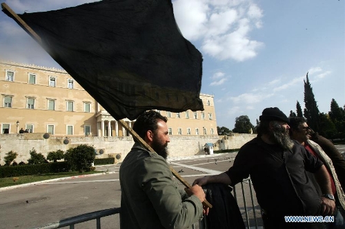 Greek farmers shout slogans and hold banners in central Athens of Greece, on March 5, 2013. Thousands of farmers from across Greece gathered in central Athens on Tuesday to rally in front of the parliament in protest of harsh austerity policies which have altered dramatically their everyday life over the past three years. (Xinhua/Marios Lolos) 
