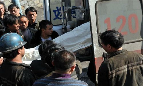 A victim of a coal mine accident is carried to an ambulance in Panxian county in the city of Liupanshui, southwest China's Guizhou Province, January 21, 2013.