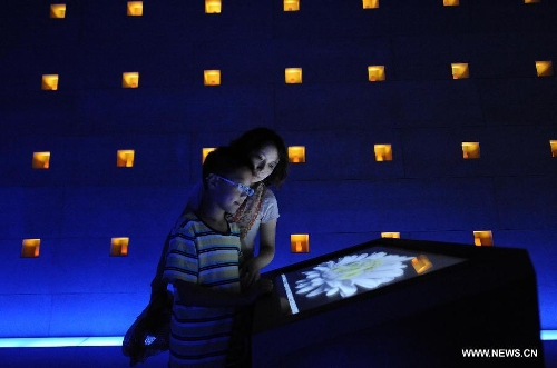 People visit the Wenchuan earthquake memorial hall in Beichuan, southwest China's Sichuan Province, May 12, 2013. Mourners gathered on Sunday in Beichuan, one of the worst hit regions in the Wenchuan Earthquake, to mark the fifth anniversary of the deadly earthquake on May 12, 2008 in which more than 80,000 people were killed or missing. (Xinhua/Xue Yubin)