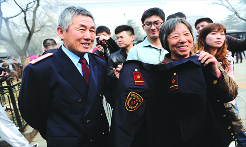 1. Yang Haowen (left), 63, a retired rail worker of 38 years, was dressed up in his uniform for photos. 