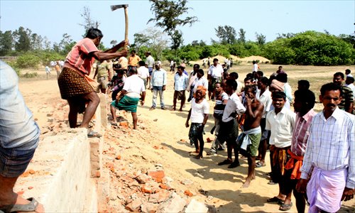 Agitated land losers raze the boundary wall at Posco project site in Nuagaon, Odisha on February 16. Photo: Basudev Mahapatra
