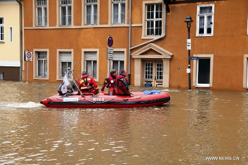 Workers carry out search and rescue operation in a hovercraft on the flooded street in Halle, eastern Germany, on June 4, 2013. The water level of Saale River across Halle City is expected to rise up to its historical record of 7.8 meters in 400 years, due to persistent heavy rains in south and east Germany. (Xinhua/Pan Xu)