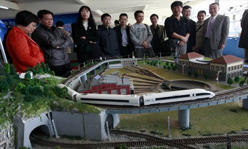 A high-speed train control simulation system designed by six teachers and students at Liuzhou Railway Vocational Technical College in Guangxi Zhuang Autonomous Region is displayed at the school Friday. The system, which has obtained a national patent, includes bridges, tunnels, villages, and railway stations, and could be used as a teaching tool. Photo: CFP 