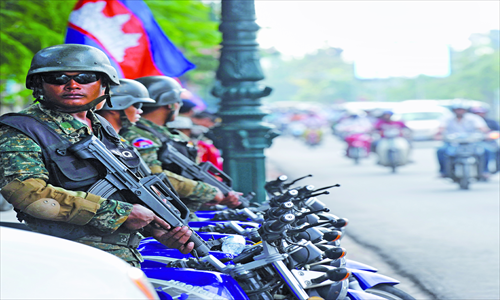 Cambodian soldiers stand guard in front of the Peace Palace, the main venue of the ASEAN annual ministerial meeting and the ASEAN Regional Forum, in Phnom Penh on Tuesday. Photo: AFP   