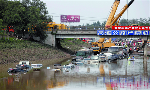 Vehicles submerged in an underpass to a highway in Fangshan Photo: GT/Li Hao