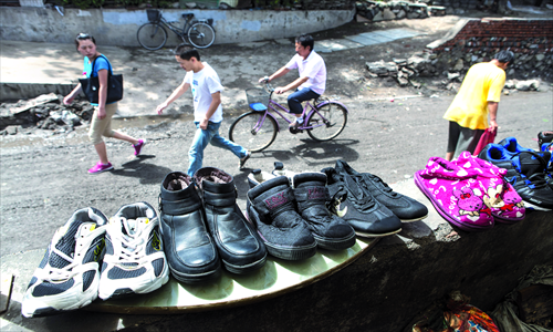 A family dries shoes in front of a house on Sunday in Beixin'an, Shijingshan district. Photos: GT/Li Hao