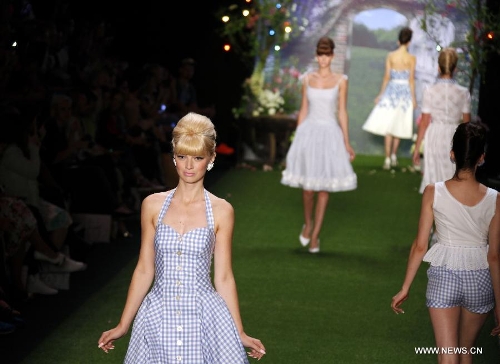 Models present creations by Austrian designer Lena Hoschek at the Spring/Summer 2014 Shows of the Mercedes-Benz Fashion Week, in Berlin, on July 2, 2013. (Xinhua/Pan Xu) 