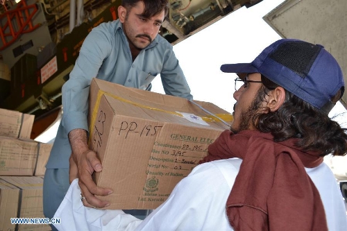 Pakistani workers unload boxes of electoral materials for the forthcoming parliamentary elections in central Pakistan's Multan on May 4, 2013. Pakistani Army has been deployed in nine out of 30 districts in sparsely populated Balochistan province. Violence has escalated as the country moves closer to historic elections, which are scheduled on May 11. (Xinhua/Stringer)