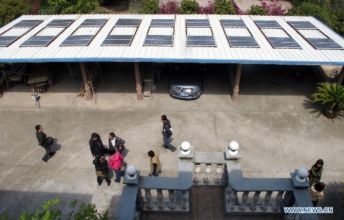 Photo taken on April 8, 2013 shows solar panels of a homemade photovoltaic power station made by a local resident named Mo Zhikai in Wumeng Village of Ningbo City, east China's Zhejiang Province. The 27-year-old Mo, an enthusiastic fan of photovoltaic power generation, installed over 70 solar panels with the capacity of 7.5 kilowatt on the roof of his own house and garage in 2009. Yet these panel were left unused as they were not allowed to be incorporated into the State Grid. Things changed as the State Grid Corporation of China released a document on Feb. 27, 2013, encouraging distributed generation to be incorporated into the State Grid. Staff members of Ningbo Power Bureau came to Mo's village for a survey of Mo's homemade photovoltaic power generation equipments on Monday. Mo will have the first homemade photovoltaic power station in Ningbo if everything goes smooth in 35 workdays. (Xinhua/Gong Guorong) 