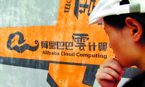 A passer-by looks at an advertisement for Alibaba Cloud Computing in Hangzhou, Zhejiang Province. Photo: CFP