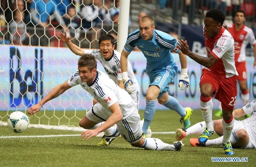 Vancouver Whitecaps' Brad Rusin (L) vies for the ball during a MLS soccer game against Portland Timbers in Vancouver, Canada, on May 18, 2013. The match ended with a 2-2 tie. (Xinhua/Sergei Bachlakov) 