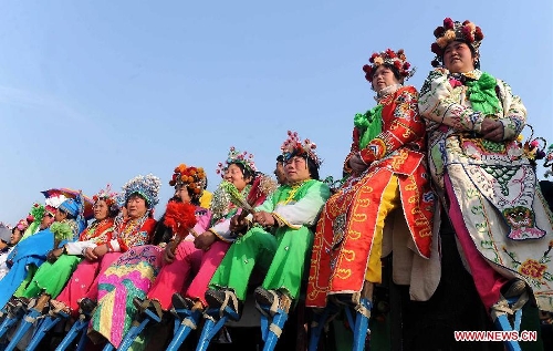 &nbsp;Performers of a local art troupe prepare to perform stilts dance during a festive activity or 