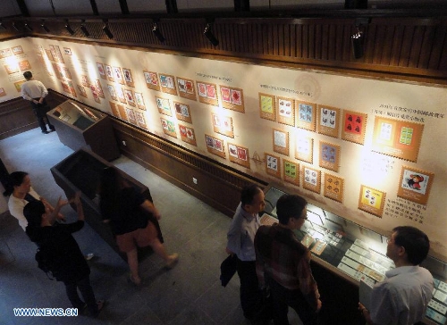 &nbsp;Visitors appreciate zodiac stamps in the Suzhou Zodiac Stamp Museum in Suzhou, east China's Jiangsu Province, May 15, 2013. The museum, which will be opened to the public free of charge on May 18, stores zodiac stamps which were issued in more than 100 countries and regions since 1950. (Xinhua/Wang Jiankang)