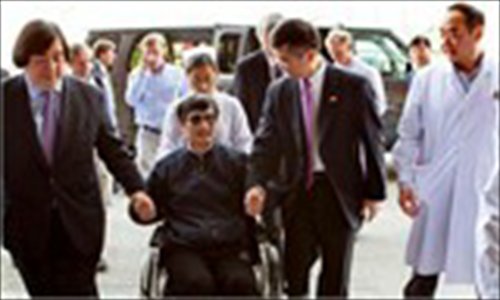 In this photo released by the US Embassy Beijing Press Office, blind lawyer Chen Guangcheng is wheeled into a hospital by U.S. Ambassador to China Gary Locke, right, and an unidentified official at left, in Beijing Wednesday May 2, 2012. Source: AP