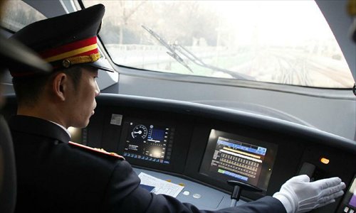 A driver operates bullet train G801 to leave for Guangzhou, capital of south China's Guangdong Province, from the Beijing West Railway Station in Beijing, capital of China, Dec. 26, 2012. The world's longest high-speed rail route linking Beijing and Guangzhou started operation on Wednesday. Running at an average speed of 300 kilometers per hour, the 2,298-kilometer new route will cut the travel time between Beijing and Guangzhou from more than 20 hours to around eight. Photo: Xinhua