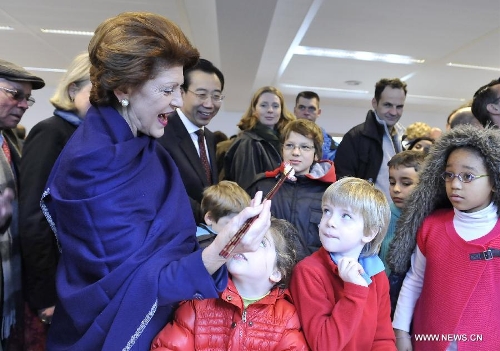 EU commissioner Androulla Vassiliou (L, front) uses chopsticks to grip a candy for pupils during an event to celebrate the Spring Festival at the 4th Brussels European School in Brussels, capital of Belgium, on Feb. 2, 2013. The Chinese embassy in EU and the 4th Brussels European School held an event to introduce Chinese Spring Festival to hundreds of pupils and their parents Saturday.(Xinhua/Ye Pingfan)