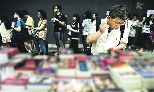 A man looks at Chinese political books at the Hong Kong Book Fair on July 18. More than 530 exhibitors from 20 countries took part in the six-day fair which drew in around 900,000 visitors. The annual event is known for shedding light on works that have been banned on the Chinese mainland. Photo: AFP