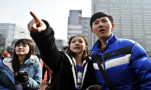 Hopeful high school students look for their names on a list of applicants who have been chosen for a second round of interviews with the Performance Institute of the Beijing Film Academy, the top film school in China, on Tuesday. Applicants from across the country have pinned their hopes for stardom on the school's decision.  Photo: CFP