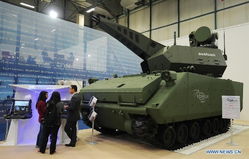 Guests view an armored vehicle of fire control system made by a Turkish company in Istanbul, Turkey, May 7, 2013. The 11th International Defence Industry Fair was opened on Tuesday, with 781 companies from 82 countries and regions attending the four-day fair. (Xinhua/Lu Zhe) 