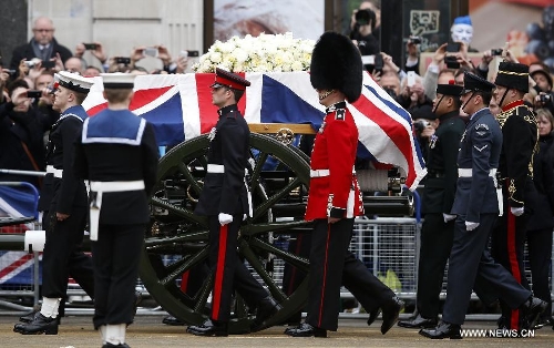 The gun carriage carrying the coffin containing the body of former British Prime Minister Margaret Thatcher arrives at St. Paul's Cathedral in London, Britain, April 17, 2013. The funeral of Margaret Thatcher, the first female British prime minister, started 11 a.m. local time on Wednesday in London. (Xinhua/Wang Lili)