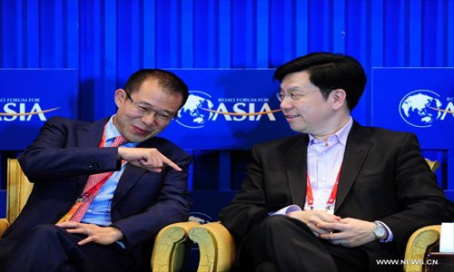 Tencent Holding Ltd. President Martin Lau (L) chats with Lee Kai-fu, chairmen and CEO of the Innovation Works, at a panel discussion titled 