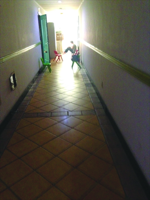 A father waits in the corridor of Chaoyang district special school Chuhe Children's Education while his autistic child attends class. Photo: Yin Lu/GT