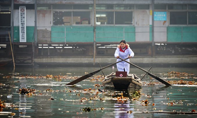 Xie sails toward some of her villager patients. Photo: CFP