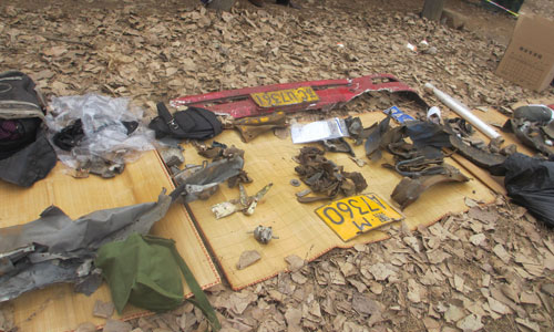 Car plates and parts of destroyed vehicles are collected near a collapsed bridge in Sanmenxia, Henan Province on Saturday. Photo: Yan Shuang /GT