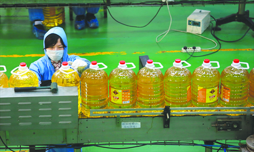 A worker packages bottled cooking oil in a factory operated by COFCO Agri-Trading & Logistics in Jiujiang, Jiangxi Province in February. Photo: CFP