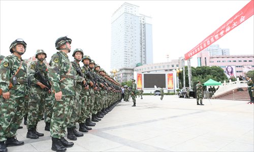 Armed police officers attend an oath-taking ceremony at the People's Square on Saturday in Urumqi, Xinjiang Uyghur Autonomous Region. At least 24 civilians and police officers were killed during a recent terrorist attack. Photo: CFP