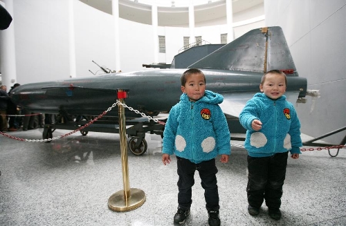 Two boys visit a missile at the weapon museum of Nanjing University of Science and Technology (NJUST) in Nanjing, capital of east China's Jiangsu Province, March 24, 2013. The NJUST opened to public to celebrate its 60th anniversary Sunday. The weapon museum collects about 6,000 weapons since the First World War. (Xinhua/Wang Xin)&nbsp; 