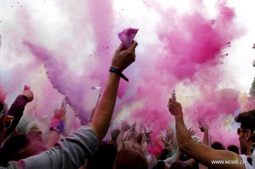 People throw colorful powder during the Holi Festival of Colours, at the Reiterstadion in Berlin, Germany, May 11, 2013. The celebration of Holi Festival of Colours has been launched in Germany since 2012 as a new carnival of German people marking the advent of spring. (Xinhua/Pan Xu) 