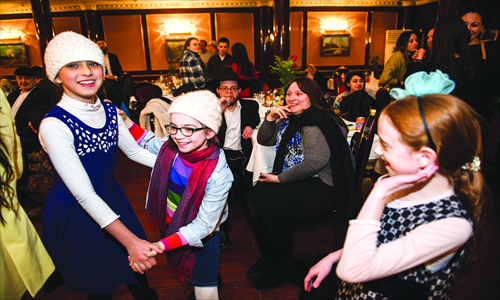 1. Children dance as Freundlich breaks into song.

