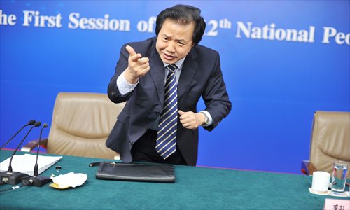 Wang Feng, deputy director of the State Commission Office for Public Sector Reform, answers questions about the State Council’s restructuring plan for the government at a press conference held Monday in the Great Hall of the People in Beijing. Photo: IC