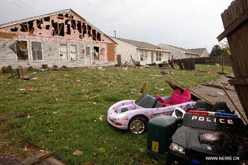 Destroyed houses and toys are seen in Moore, Oklahoma, May 21, 2013, one day after a tornado moved through the area. A powerful tornado attacked on Monday afternoon the southern suburbs of the Oklahoma City, capital of the U.S. state of Oklahoma, killing at least 24 people, including 9 children. (Xinhua/Song Qiong)