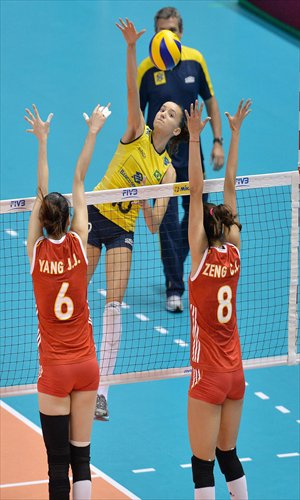 Gabriela Guimaraes (center) of Brazil spikes the ball against China during their FIVB World Grand Prix Finals match on Sunday in Sapporo Japan. Photo: CFP