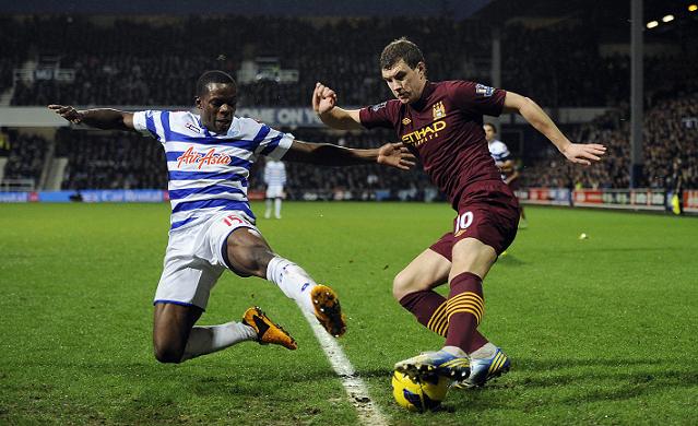 Queens Park Rangers' Nedum Onuoha (left) tackles Manchester City's Edin Dzeko on Tuesday. Photo: CFP