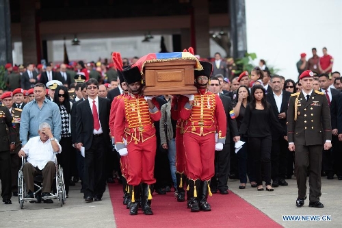 The body of late Venezuelan President Hugo Chavez is carried from the Military Academy to the Mountain Barracks, in the city of Caracas, capital of Venezuela, on March 15, 2013. Venezuelans honored late President Hugo Chavez, before his remains were transfered to the Mountain Barracks, where he will rest inside a glass case. Venezuelan President died on March 5, after struggling with cancer for two years. (Xinhua/AVN) 
