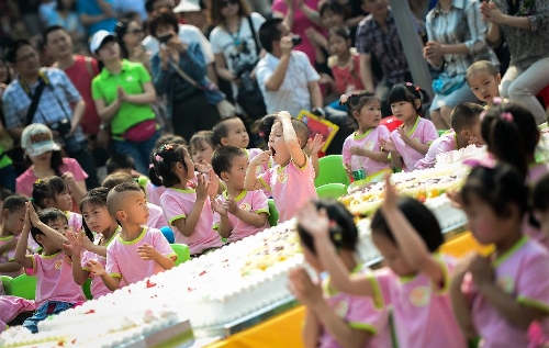 Children take part in a birthday party at the Luohan Temple in Shifang City, southwest China's Sichuan Province, May 12, 2013. The children were born at the Luohan Temple five years ago after the devastating earthquake jolted Wenchuan County of Sichuan on May 12, 2008. The temple then was used as a temporary obstetrics hospital from May 13 to Aug. 7 in 2008 to deliver newborn babies. A total of 108 babies were born at the temple until the local maternal and child health care hospital reopened. (Xinhua/Jiang Hongjing) 